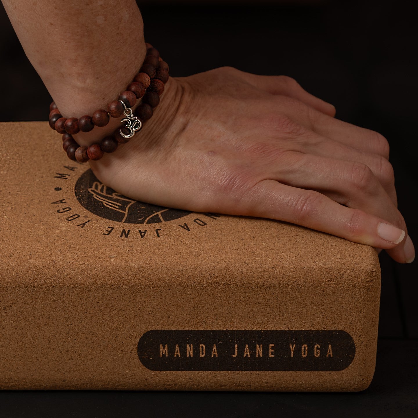 Hand wresting on Manda Jane Yoga cork yoga block.